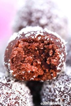 chocolate covered doughnuts stacked on top of each other with powdered sugar and sprinkles