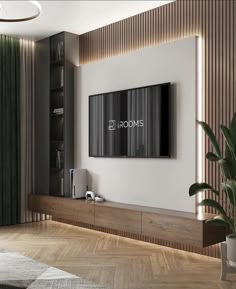 a living room with a large tv mounted on the wall and wooden flooring in front of it