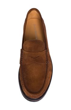 A classic penny keeper and supple suede upper lend timeless sophistication to a luxe loafer grounded by a cushioned footbed and slip-resistant lug sole. Multilayered, PORON®-cushioned footbed Slip-resistant sole Weatherproof Leather upper and lining/rubber sole Made in Italy Brown Wingtip Moccasins With Suede Lining, Masculine Suede Loafers With Plain Toe, Masculine Suede Moc Toe Loafers, Brown Wingtip Suede Moccasins, Timeless Suede Loafers With Round Toe, Masculine Suede Slip-on Loafers, Classic Moccasins With Suede Lining For Work, Brown Suede Moccasins For Semi-formal Occasions, Semi-formal Brown Suede Moccasins