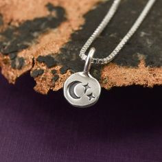 Description Take your style to new heights with our Twinkling Crescent Moon Charm. This small charm features a gorgeous crescent moon design adorned with sparkling stars, adding a touch of whimsy to any look. Perfect for those who love the magic of the nighttime sky. Make a wish upon this charm and let it bring a touch of sparkle to your everyday life! Details Recycled sterling silver. Size = 1/4" (.64cm) in diameter. This listing is for one charm only, chain sold separately. Charms do not readi Crescent Moon Design, Nighttime Sky, Sparkling Stars, Small Charms, Moon Charm, Moon Design, Recycled Sterling Silver, Make A Wish, Crescent Moon