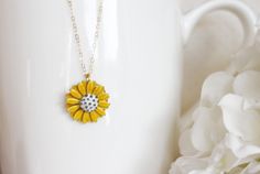 "This pendant is from my vintage garden collection, sweet adorable tiny yellow enamel daisy measures 50\" in diameter. Hangs from a new 14 karat gold filled cable chain . Spring closure clasp. The Daisy is vintage an in mint condition The model is wearing a 16\" length. H A N D M A D E * We hand make all pieces in our Water Mill New York studio * We source eco friendly packaging and materials, including recyclable mailers! FREE BOX AND WRAP ON EVERY ORDER P R O D U C T I O N ∙ T I M E S All item Vintage Yellow Enamel Jewelry, Vintage Gold Jewelry With Sunflower Design, Gold Flower Necklace With Vintage Charm, Dainty Yellow Flower Shaped Jewelry, Cute Yellow Flower Shaped Jewelry, Yellow Flower-shaped Enamel Jewelry, Delicate Yellow Flower Necklace, Dainty Yellow Flower Necklace, Yellow Enamel Flower Shaped Jewelry