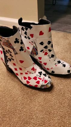 a pair of shoes with playing cards on them