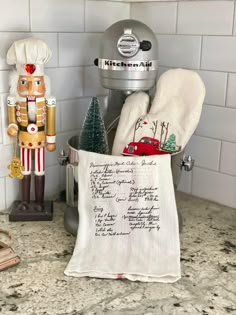 a kitchen counter with an oven mitt, tea towel and nutcracker