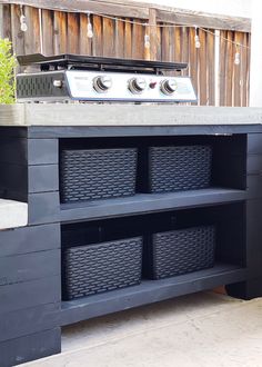 an outdoor grill with baskets on it