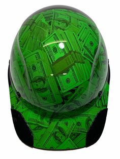 a green motorcycle helmet with money on it