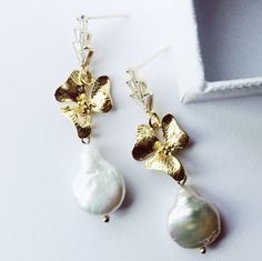 Handcrafted freshwater pearl earrings. Beautiful statement earrings for any occasion.  24K gold plated with faceted zircona crystal ear posts.   Hand-wired gold floral elements and freshwater pearl drops with incredible lustre. All freshwater pearls are unique and as such there will never be an exact match, each pair will have beautiful irregularities. Earring drop 5cm  All of our accessories are beautifully packaged in luxury boxes with acid-free tissue paper, tied with exclusive Garter & Veil grosgrain ribbon. SHOP MORE STYLES. www.garterandveil.etsy.com FIND ME ON www.instagram.com/garterandveil All orders sent within the UK are sent via signed for 1st class signed for. International orders will be sent tracked and signed where possible. Gold Bridal Earrings With Pearl Charm, Yellow Gold Baroque Pearl Earrings For Wedding, Delicate Gold Pearl Earrings For Anniversary, Gold Baroque Pearl Bridal Earrings As Gift, Gold Baroque Pearl Bridal Earrings For Gift, Gold Pearl Bridal Earrings For Anniversary, Gold Delicate Baroque Pearl Earrings, Delicate Gold Baroque Pearl Earrings, Gold Baroque Pearl Earrings For Anniversary