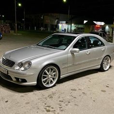 a silver car parked in a parking lot at night