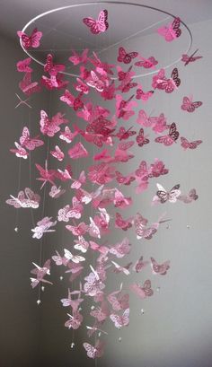 pink butterflies are hanging from the ceiling