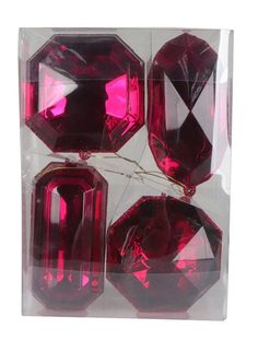 four red glass beads in a clear package