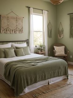 a bedroom with green walls and white bedding in the corner, along with a wicker basket hanging on the wall