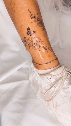 a woman's leg with tattoos on it