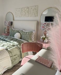 a bed room with a neatly made bed and pink chairs