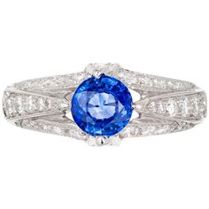 Tacori platinum sapphire and diamond Tacori engagement ring. The Center sapphire is accented on each size with round brilliant cut diamonds graduating from small to large with diamonds also set across shank of ring. 1 round blue sapphire Approximate .93 carats GIA certificate # 2191292073 38 round brilliant cut H-I VS diamonds Approximate .60 carats Size 6.75 and sizable Platinum Stamped: Plat Hallmark: Tacori 7.4 Grams 8.38mm wide at top 6.44mm high at top 2.47 wide at bottom Brilliant Cut Sapphire Diamond Ring In Platinum, Sapphire Diamond Ring With Brilliant Cut In Platinum, Platinum Sapphire Diamond Ring With Brilliant Cut, Exquisite Sapphire Diamond Ring With Brilliant Cut, Sapphire Diamond Ring With Prong Setting In Platinum, Dazzling Brilliant Cut Sapphire Ring In Platinum, Dazzling Platinum Sapphire Ring, Gia Certified Platinum Sapphire Ring, Round Cut, Exquisite Platinum Sapphire Ring With Center Stone