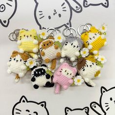 small crocheted keychains with cats and flowers on them