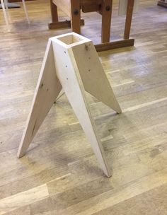 a wooden table that has some kind of triangular design on it, sitting in the middle of a room