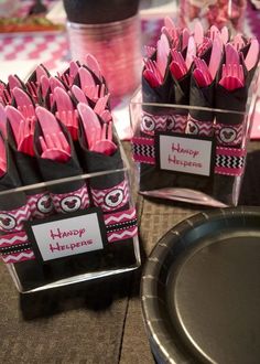 some pink and black birthday decorations on a table