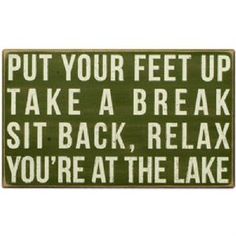 a sign that says put your feet up take a break sit back relax you're at the lake