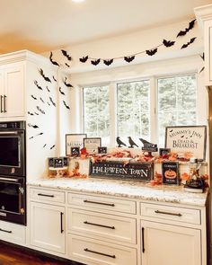 the kitchen is decorated for halloween with bats