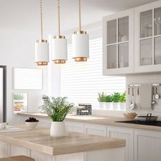 a kitchen with white cabinets and wooden counter tops