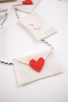 several envelopes with felt hearts attached to them