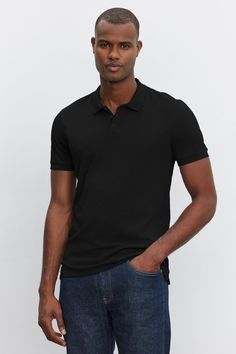 A man wearing a black heathered texture NIKO POLO shirt and blue jeans standing against a white background Black Collared Cotton Polo Shirt, Black Cotton Collared Polo Shirt, Black Fitted Cotton Polo Shirt, Fitted Black Cotton Polo Shirt, Fitted Cotton Button-up Polo Shirt, Classic Black Polo Shirt With Button Closure, Black Polo Shirt With Button Closure For Work, Casual Black Polo Shirt, Fitted Button-up Polo Shirt