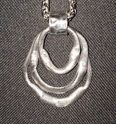 "Beautiful silver triple dangle necklace.  Hand-shaped pewter then heat-forged to its melting point.  May be worn two different versions as pictured.  Triple circle dangle is 2.75\" long and 1.75\" wide.  If worn with one circle up and two down, length of pendant is then 3.25\".  Comes on the wheat design chain as pictured, but you may choose your chain length.  Free shipping!  Comes gift-boxed with a polishing cloth included.  You will always receive the exact item pictured and described. Made Layered Metal Jewelry, Chunky Pendant Necklace, Melting Silver, Chunky Silver Jewellery, Hand Forged Jewelry, Chunky Silver Necklace, Jewel Tattoo, Wheat Design, Pewter Jewelry