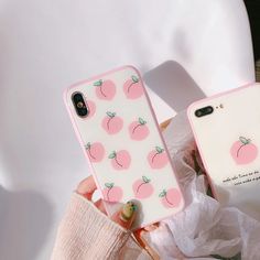 two cases with pink apples on them sitting next to each other