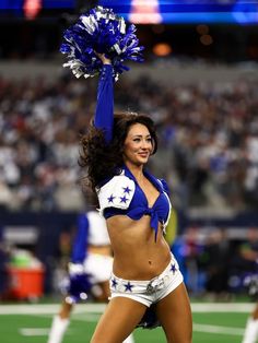 a cheerleader performs during a football game