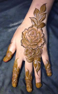 a woman's hand with hennap and flowers painted on the palm area