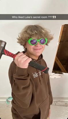 a young boy wearing sunglasses and holding a hammer in front of his face with the caption, who liked like secret room????????????????????????????????