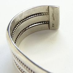 This is a Vintage Navajo Fred Maloney Heavy Sterling Cuff Bracelet 52 Grams Signed FM. This bracelet is signed FM Sterling, possibly for Navajo artist Fred Maloney. The bracelet is heavy, weighing 52.3 grams, and the bracelet measures 5 1/4 inches around plus a 1 3/8 inches gap for a total of 6 5/8 inches. The width is 3/4 inch. The bracelet is too big for my 6 1/4 inch wrist. There is no flexibility for size adjustment, as the silver is too thick. #2289650 More Native American Jewelry https://w Southwestern Adjustable Cuff Bracelet, Adjustable Southwestern Cuff Bracelet, Southwestern Style Adjustable Stamped Bangle, Southwestern Jewelry, Vintage Navajo, Bracelet Sterling Silver, Sterling Silver Cuff, Pinky Ring, American Jewelry