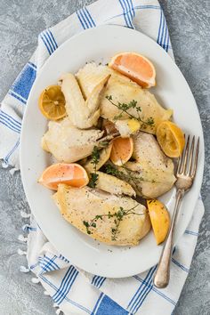 a white plate topped with chicken and orange slices