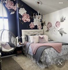 a bedroom with floral wallpaper and chandelier