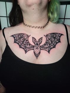 a woman with a bat tattoo on her chest