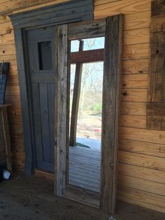 an open door is shown in the corner of a room with wooden walls and flooring