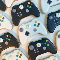 decorated cookies in the shape of video game controllers are arranged on top of each other