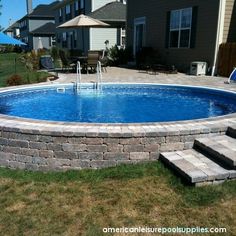 an above ground swimming pool with steps leading up to it and a patio area in the background