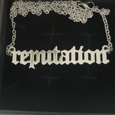 a necklace with the word repuptation on it