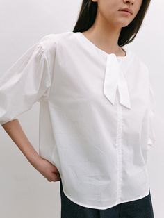 Editor's NotesThis blouse is made of cotton, nylon, and span. It features a dropped shoulder and shirring detail, and a feminine mood. Wear this item with short pants and sandals for a perfect daily look. - Classic design long-sleeve blouse- Relaxed fit and a comfortable fit - Semi-cropped length and volume sleeve- Ribbon detail on the neckline  Measurements(in.)One size (XS-M)- Shoulder: 20.07 in. - Chest: 21.65 in. - Sleeve Length: 20.86 in. - Total Length: 23.62 in. Model Info: Mahina Height 5' 67, Wearing S size  Composition & Care- Shell: 67% Cotton 30% Nylon 3% Span  - Dry Clean Recommended Designer- by LAMINEZ Spring Poplin Tops With Relaxed Fit, Effortless Cotton Blouse For Daywear, Cotton Puff Sleeve Blouse With Tie Sleeves, Cotton Blouse With Tie Sleeves And Puff Sleeve, Chic Poplin Blouse For Daywear, Chic Poplin Top With Relaxed Fit, Relaxed Fit Cotton Blouse For Daywear, Chic Daywear Poplin Blouse, Effortless Cotton Blouse For Day Out