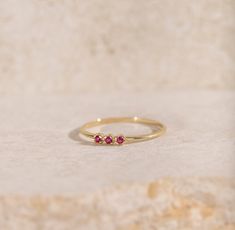 A stacking ring for women with ruby in 14K solid yellow gold. A dainty minimalist 3 stone ring for women with natural gemstones and a great birthday gift as ruby is the July birthstone. 100% handcrafted with love! * Material: 14K solid gold, 14K white gold * Gemstones: Ruby, round cut * Gemstones' Weight: 0.06 ct HOW TO ORDER * Choose from the drop-down menus the available options (Ring size, Material) and leave us a note for any special requirements. PRODUCTION TIME - SHIPPING POLICIES * Please Fine Jewelry Stackable Ruby Promise Ring, Ruby Stackable Promise Ring, Promise Ruby Ring In 14k Gold, Ethically Sourced, Three Stone Ruby Ring In Yellow Gold, Dainty Ruby Ring For Promise, Three Stone Ruby Ring In 14k Yellow Gold, Fine Jewelry Ruby Stackable Rings, Fine Jewelry Stackable Ruby Rings, Stackable 14k Gold Ruby Ring For Promise