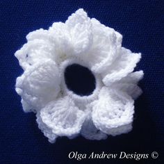 a crocheted white flower on a blue background