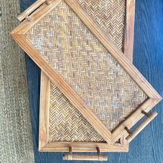 two wooden frames with handles made out of wood and wicker on the floor next to each other