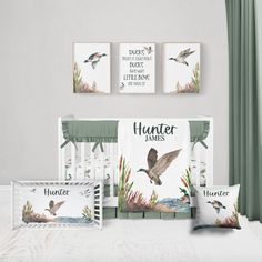 a baby crib bedding set with birds and watercolors on the wall