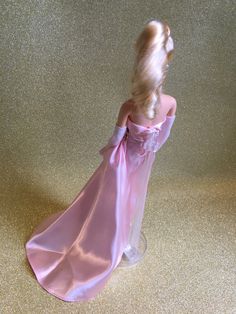 Barbie vintage blonde reproduction collection-Mattel-Enchanted Evening-1996 Barbie vintage blonde reproduction collection-Mattel-Enchanted Evening-1996 Beautiful Barbie wearing her pink strapless satin evening gown with a pink rose detail at the waistline, and white fur, pink satin lined stole, triple strand pearl choker necklace, pearl earrings, clear see through gold glitter peep toe stiletto shoes, and long white evening gloves. She comes with her clear plastic original Barbie stand and pink Strapless Pink Gown For Debutante Ball, Feminine Pink Satin Evening Dress, Pink Satin Finish Evening Dress For Gala, Pink Feminine Gown For Gala, Feminine Pink Gown For Gala, Pink Strapless Dress With Satin Finish, Pink Satin Gown For Debutante Ball, Pink Satin Finish Evening Gown, Pink Satin Gown For Gala