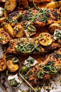 grilled chicken with herbs and potatoes on a platter