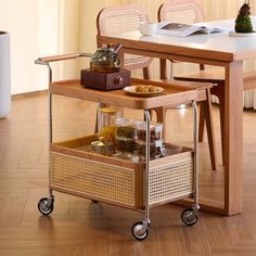 a table with two baskets on it and some food in front of the top shelf