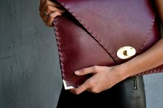 "Bordeaux Symmetria Clutch. The perfect bag for all occasions! Ideal for cocktail and parties or for business meetings depending the size you choose. You can use it as a chic briefcase for your work or as a modern large clutch for a night out. This adorable clutch is handmade out of a genuine, lux Italian bordeaux cow leather. -Small size fits all your essentials, wallet, keys, mobile, cosmetics etc. -Large size fits a 15\" laptop, ipad, portofolio etc and it's perfect as a file folder or as mod Modern Envelope Clutch For Office, Leather Envelope Clutch For Office, Elegant Envelope Bag With Laptop Sleeve, Modern Leather Envelope Clutch, Large Clutch, Leather Clutch Bag, Envelope Clutch, Leather Clutch Bags, File Folder