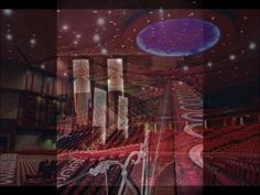 an image of a large auditorium with red seats and stars in the sky above it