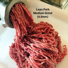 the ground beef is being milled into a bowl