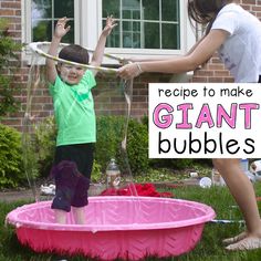 two young children playing in a pink plastic tub with the words recipe to make giant bubbles